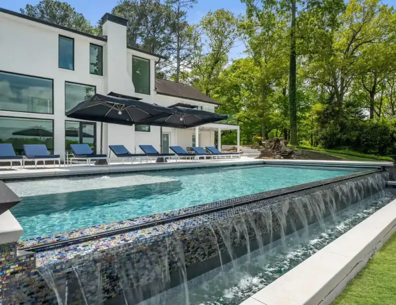 Modern house with a long sheer-descent pool wall